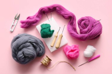 Yün işleme, iğne, iplik kesici ve pembe arka plan için ipli kompozisyon