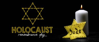 Burning candle and Jewish badge on dark background. International Holocaust Remembrance Day