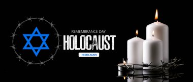Burning candles and barbed wire on dark background. International Holocaust Remembrance Day