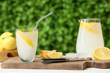 Dışarıdaki beyaz ahşap masada naneli taze limonata.