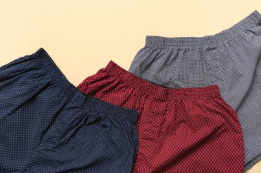 Bej arka planda şık erkek mayoları