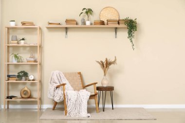 Oturma odasının içinde sandalye, sehpa ve raf ünitesi var.