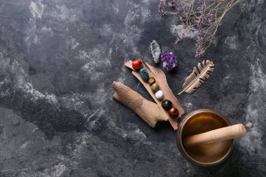 Arka planda çakra taşları, çiçekler ve Tibet şarkı kasesi seti