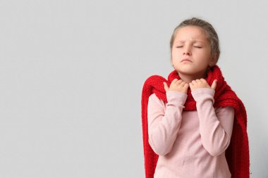 Hafif arka planda boğazı ağrıyan hasta küçük kız.