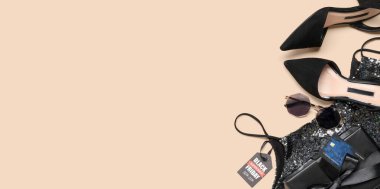 Şık kadın kıyafetleri, aksesuarlar ve bej arka planda hediye kutusu, mesaj için yer var. Kara Cuma indirimi