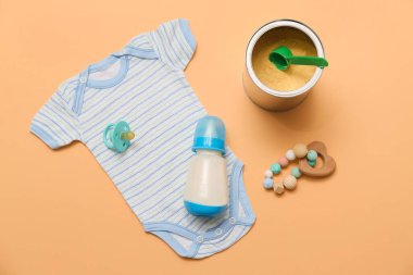 Bebek sütü formülü, beden giysisi ve aksesuarlarla dolu bir şişe.