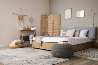 Şık bir yatak odası. Masası, perdesi ve puf.