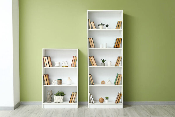 Book shelves near green wall in room