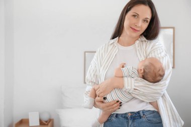 Mutlu anne küçük bebeğini kucağında tutuyor