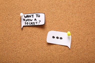 Speech bubbles with question WANT TO KNOW A SECRET? on pin board. Gossip concept clipart