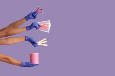 Many female hands with wax strips, razors and jar of sugaring paste on purple background. Depilation concept clipart