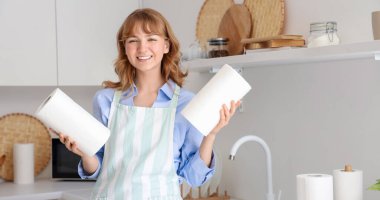 Mutfakta kağıt havluları olan genç bir kadın.