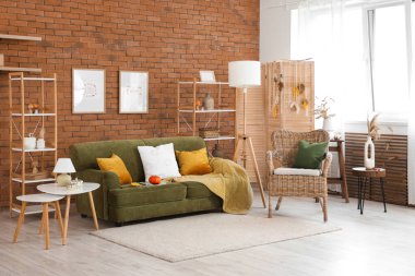 Sonbaharda oturma odasının içinde balkabağı, koltuk ve kahve masası olan rahat bir kanepe.