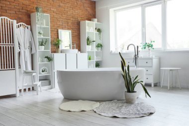 Küveti, lavabosu ve raf ünitesi olan şık bir banyo.