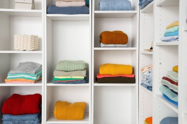 Soyunma odasında kıyafetleri olan bir gardırop. Yakın çekim.