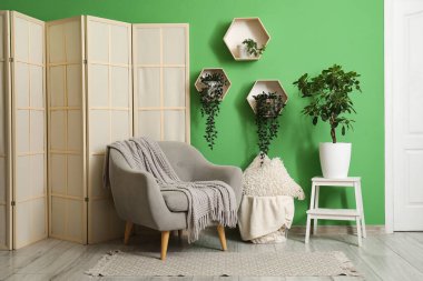 Çiçekler, yumuşak koltuklar ve güzel oturma odasının iç tarafında katlanan perdeler.