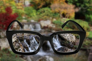 Güzel şelaleye gözlüklerle bak.