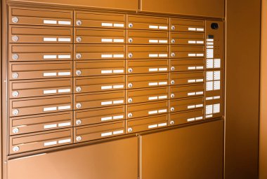 Brown mailboxes in residential building clipart