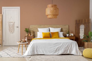 Yatak odasının içinde masalar, perdeler ve kapılar var.