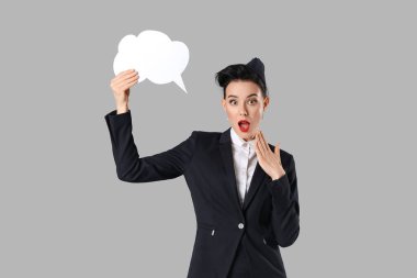 Gri arkaplanda boş konuşma balonuyla şok olmuş hostes.