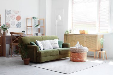 Rahat bir kanepe, oturma odasının iç tarafındaki dekorlu ve sandıklı kahve masası.