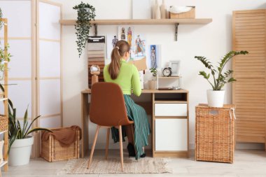 Atölyede kadın terzi kesim kalıbı, arka görünüm