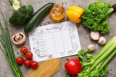 Sağlıklı ürünler ve gri grunge arka planda haftalık yemek planı. Diyet kavramı