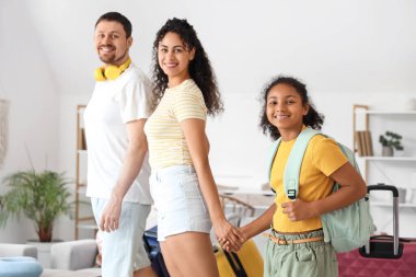 Happy family with packed suitcases for travel at home clipart