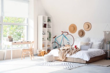 Yatak odasının içinde kahvaltı, kitap ve dizüstü bilgisayar var.