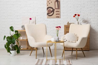 Koltuklar ve güzel Gerbera çiçekleri oturma odasının içinde.