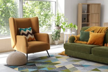 Modern oturma odasının içinde şık bir kanepe ve koltuk var.