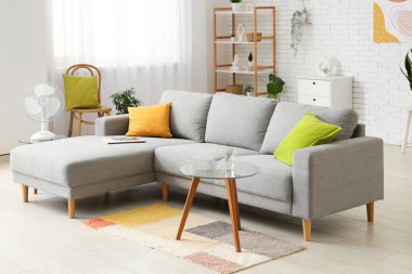 Evdeki sehpanın üzerinde modern elektrikli vantilatör.