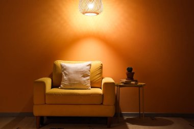 Parlak lambalı, sarı koltuklu ve gece masalı karanlık odanın içi.