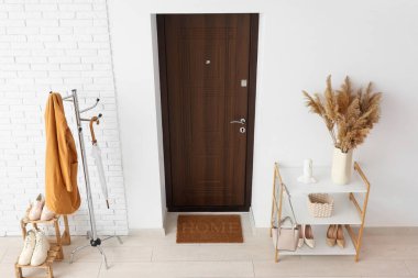 Paspası, askısı ve ayakkabısı olan modern koridorun içi.