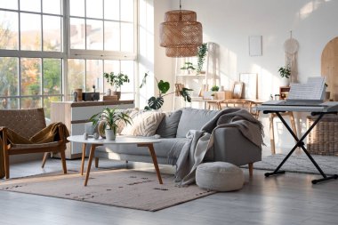 Koltuğu, koltuğu ve sentezleyicisi olan bir oturma odası.