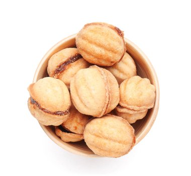 Bowl of sweet walnut shaped cookies with boiled condensed milk on white background clipart