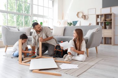 Babalarının evde mobilya montajı yaptığı sevimli çocuklar.