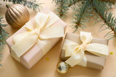 Toplu Noel ağacı dalları ve bej arka planda hediye kutuları