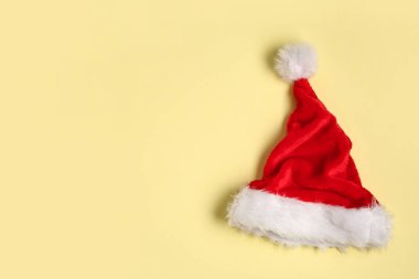 Açık sarı arka planda Noel Baba şapkası