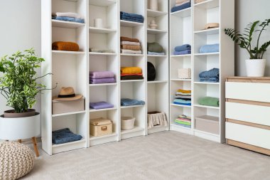 Giysileri ve çekmeceleri soyunma odasında olan büyük bir dolap.