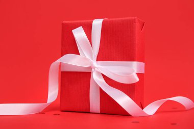 Gift box on red background. Valentine's Day celebration