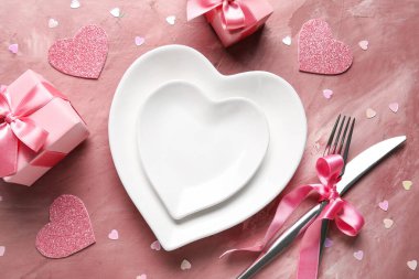 Beautiful table setting with hearts and gift boxes on pink background. Valentine's Day celebration clipart