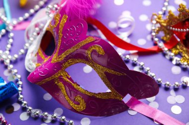 Leylak arkaplanlı güzel pembe karnaval maskesi. Yakın çekim.