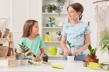 Children planting at table in workshop clipart