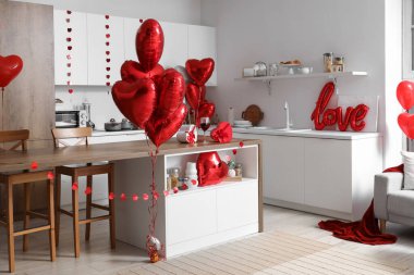 Interior of kitchen decorated for Valentine's Day with counters and heart-shaped balloons