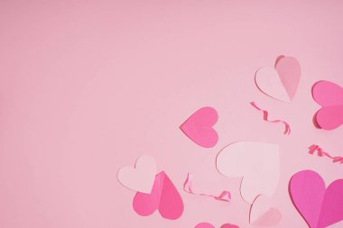 Hearts and shredded paper on pink background. Valentine's Day celebration