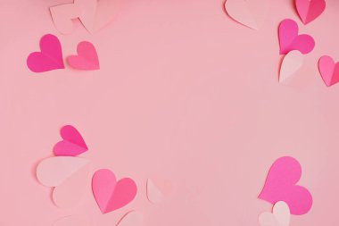 Frame made of paper hearts on pink background. Valentine's Day celebration