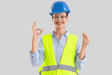 Kulak tıkacı olan kadın inşaatçı açık arkaplanda iyi görünüyor