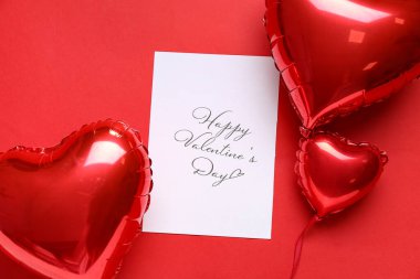 Card with text HAPPY VALENTINE'S DAY and heart shaped balloons on red background