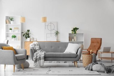 Koltuğu, koltuğu ve raf ünitesi olan bir oturma odası.